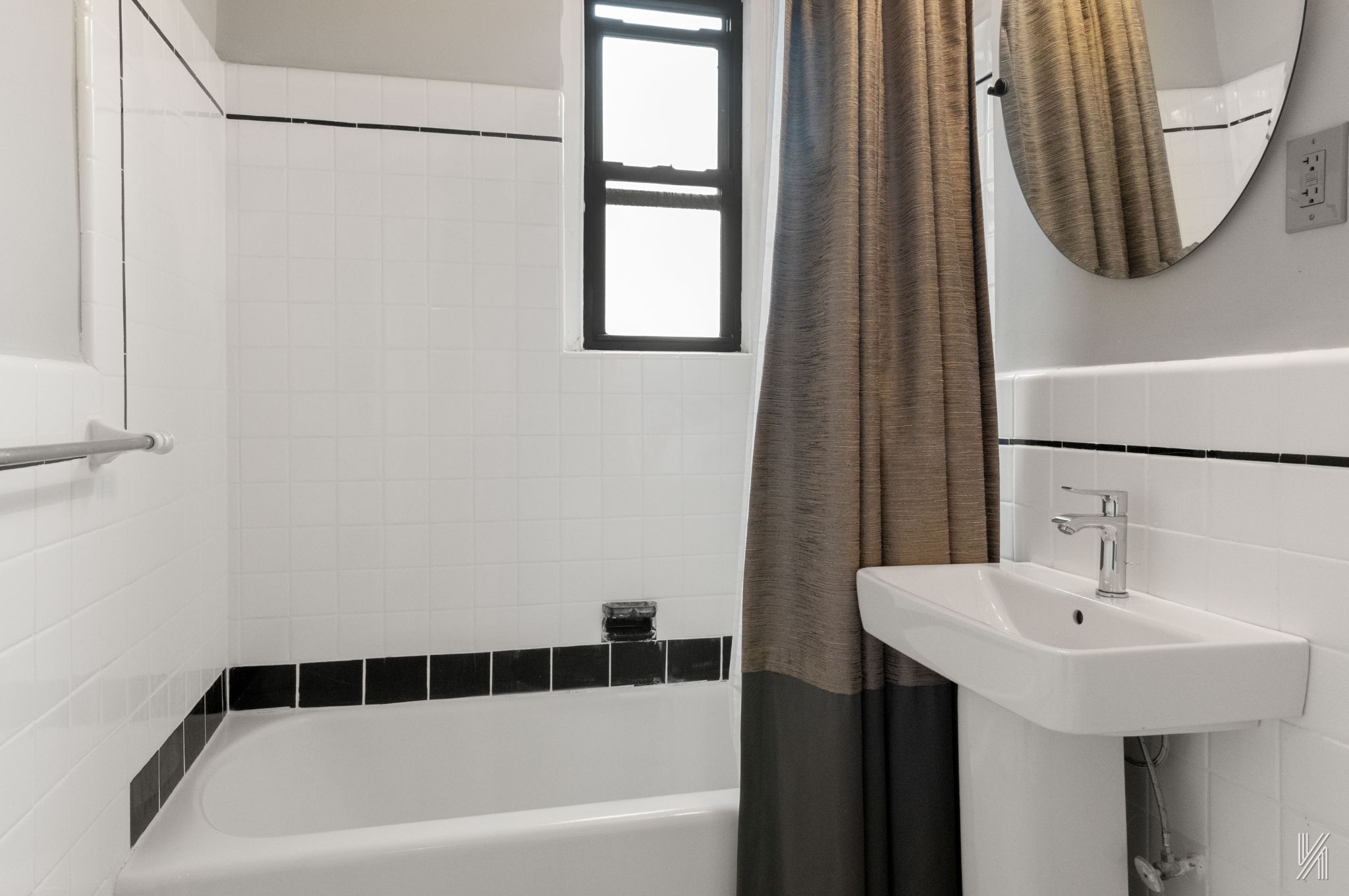 25-40 31st Avenue, Unit 6F Queens, NY 11106 - Photo 14 of 19 a bathroom with a sink a bathtub and a mirror