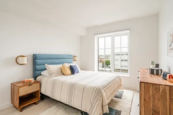 a bedroom with a bed and a window