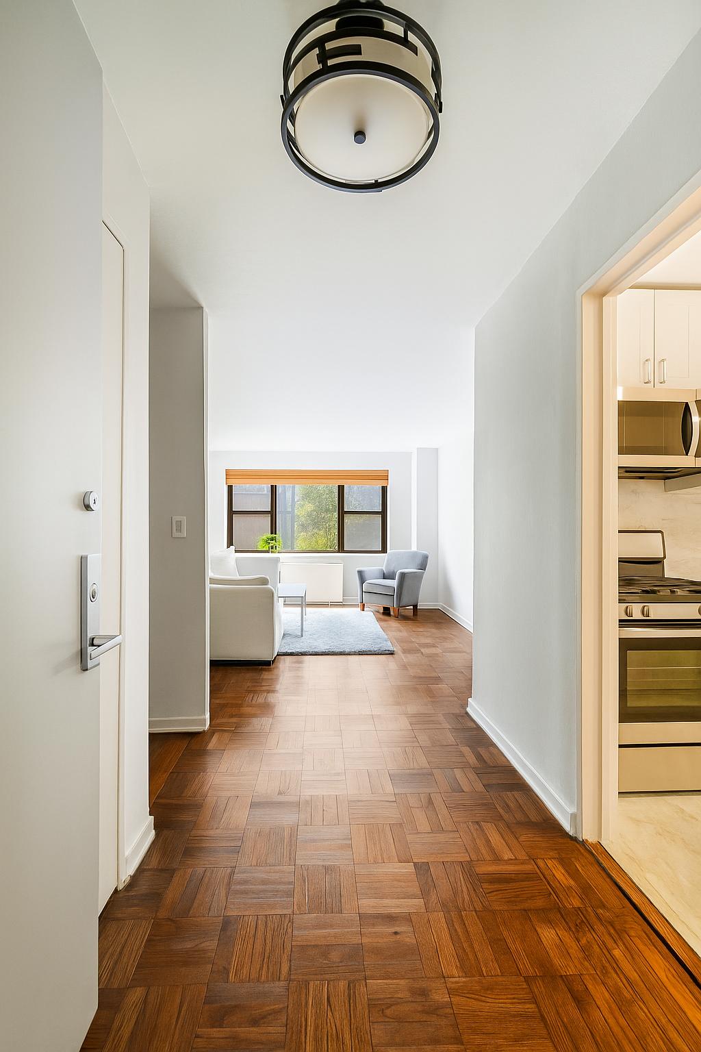 301 East 69th Street, Unit 3M Manhattan, NY 10021 - Photo 2 of 12 a view of a bedroom with a bed and wooden floor