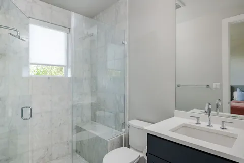 a bathroom with a sink toilet and shower