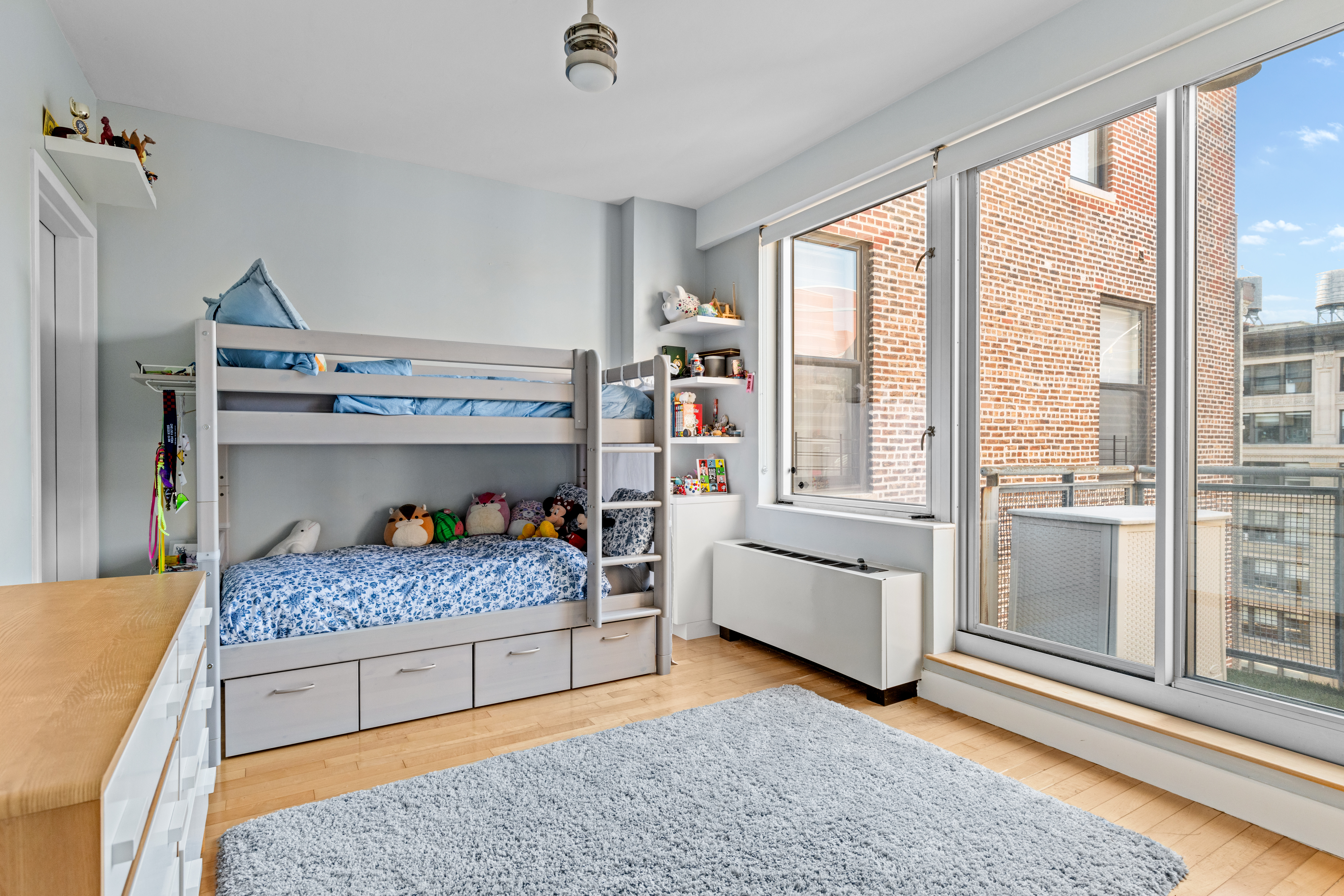 146-148 West 22nd Street, Unit PH Manhattan, NY 10011 - Photo 7 of 12 a bedroom with a bed and large window with the outer view