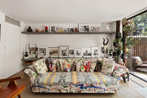 a living room with furniture and a floor to ceiling window