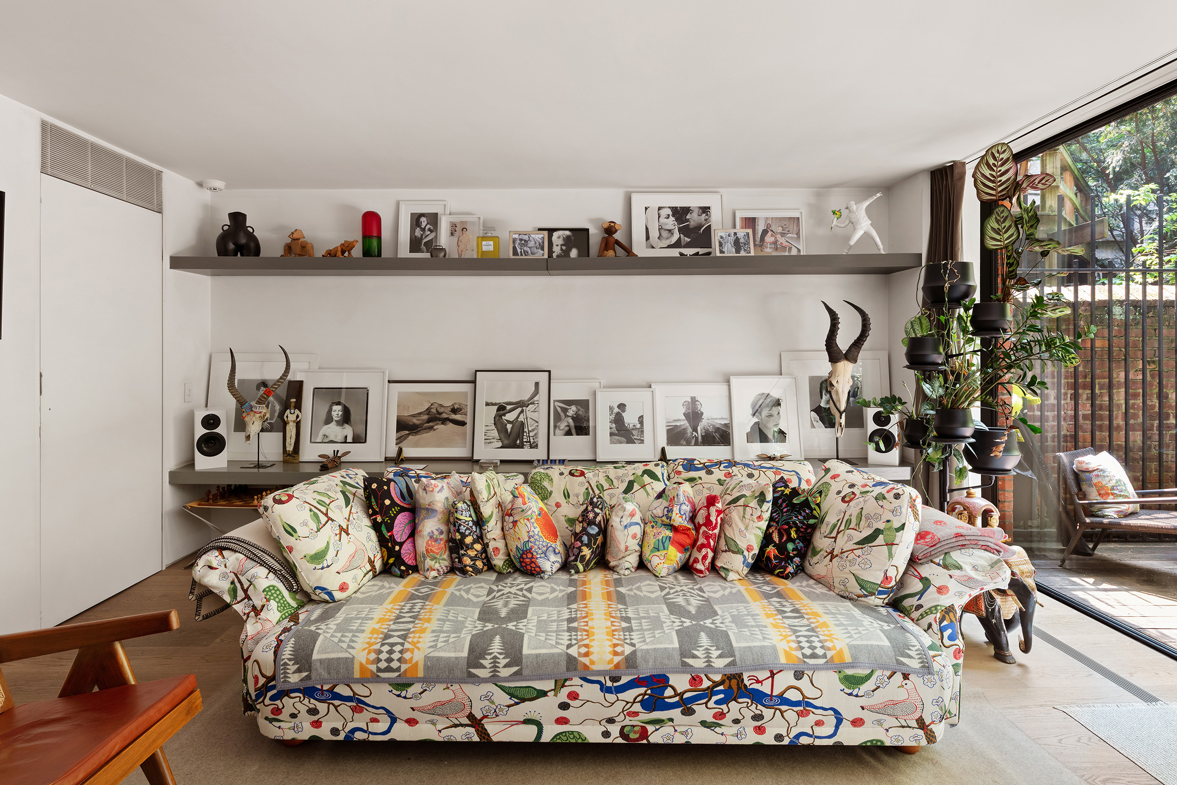 456 West 25th Street Manhattan, NY 10001 - Photo 4 of 22 a living room with furniture and a floor to ceiling window