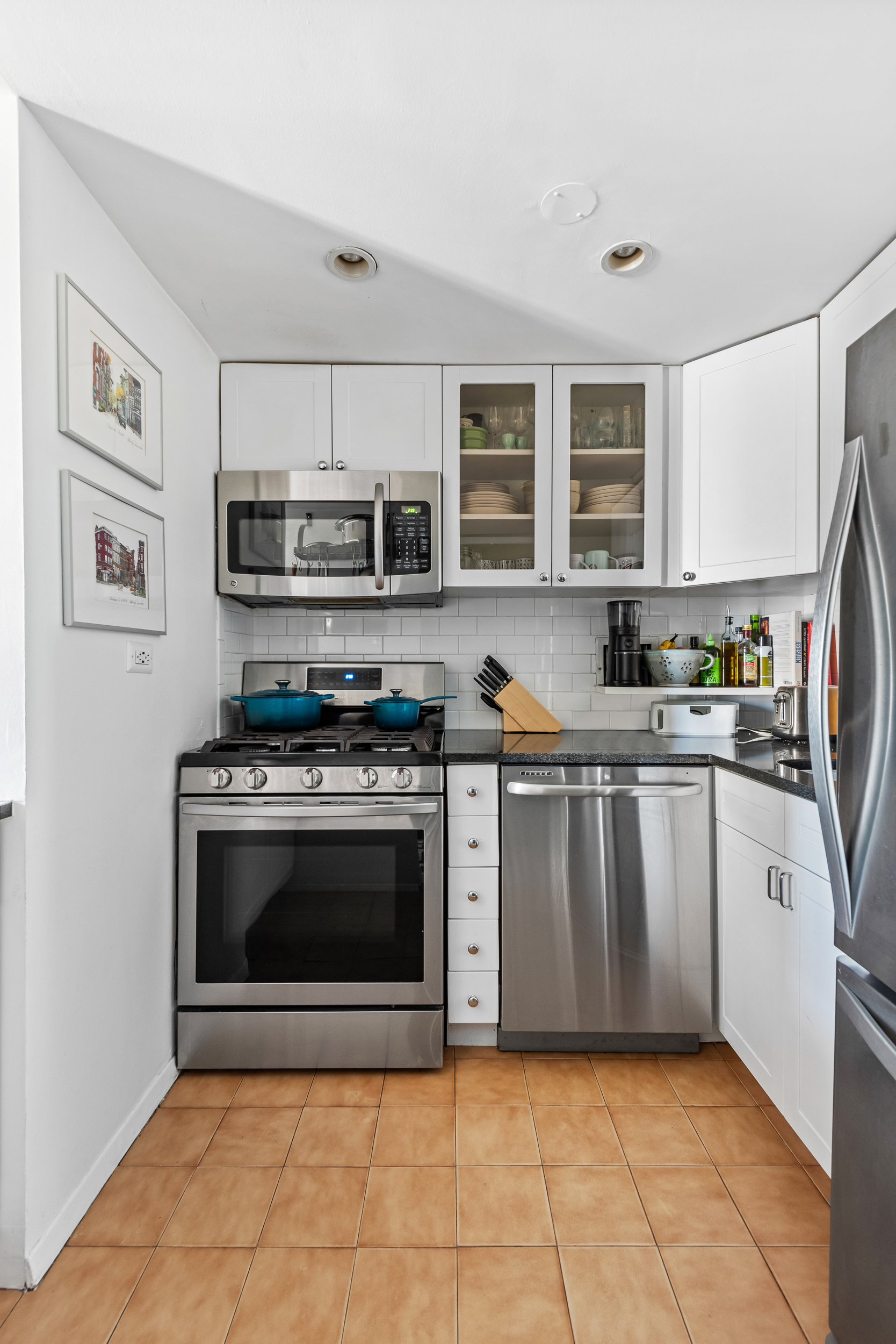 55 Poplar Street, Unit 4K Brooklyn, NY 11201 - Photo 7 of 15 a kitchen with stainless steel appliances granite countertop a stove top oven a sink dishwasher and a refrigerator