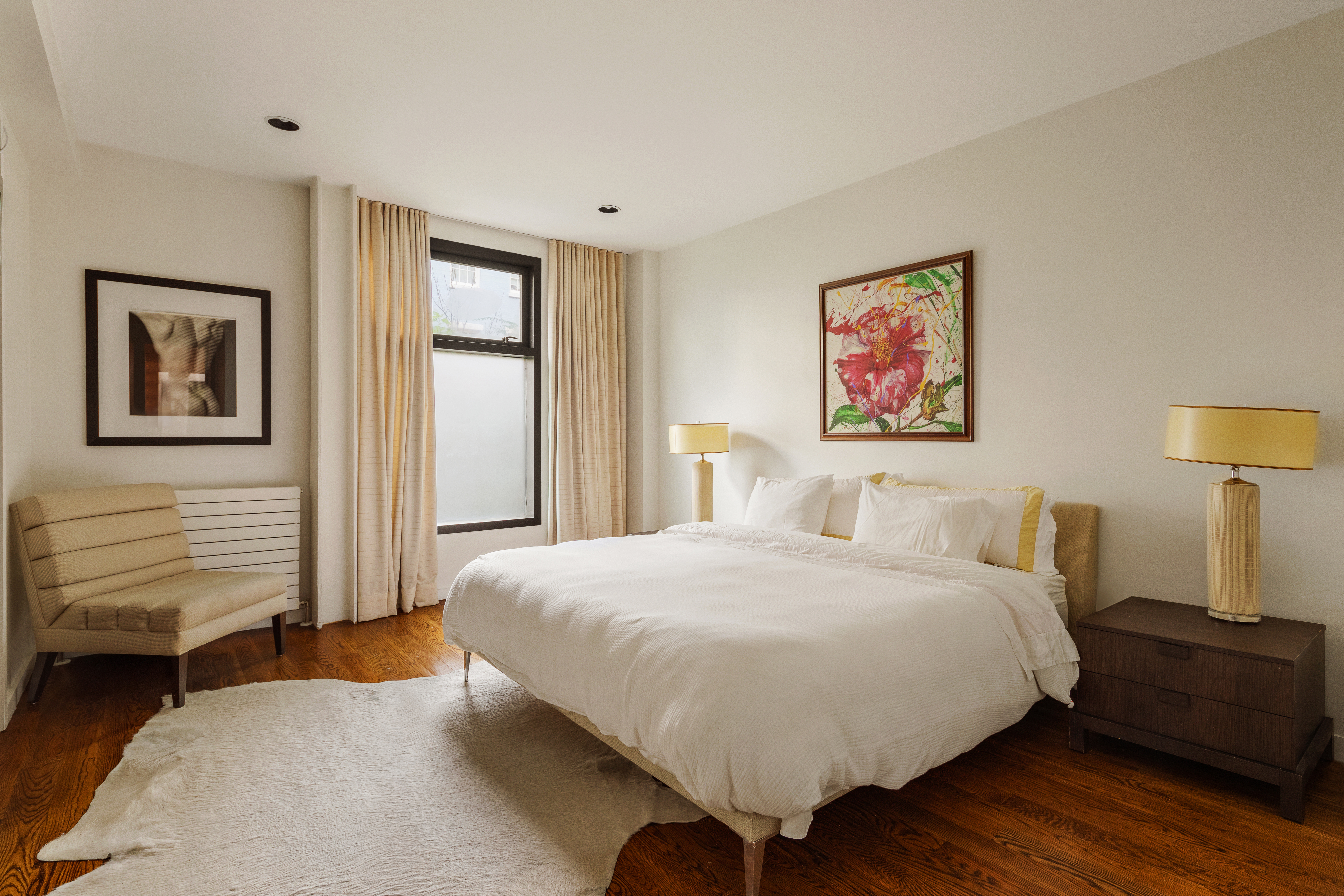 181 Sullivan Street, Unit GARDEN Manhattan, NY 10012 - Photo 5 of 10 a bedroom with a bed and a painting on the wall