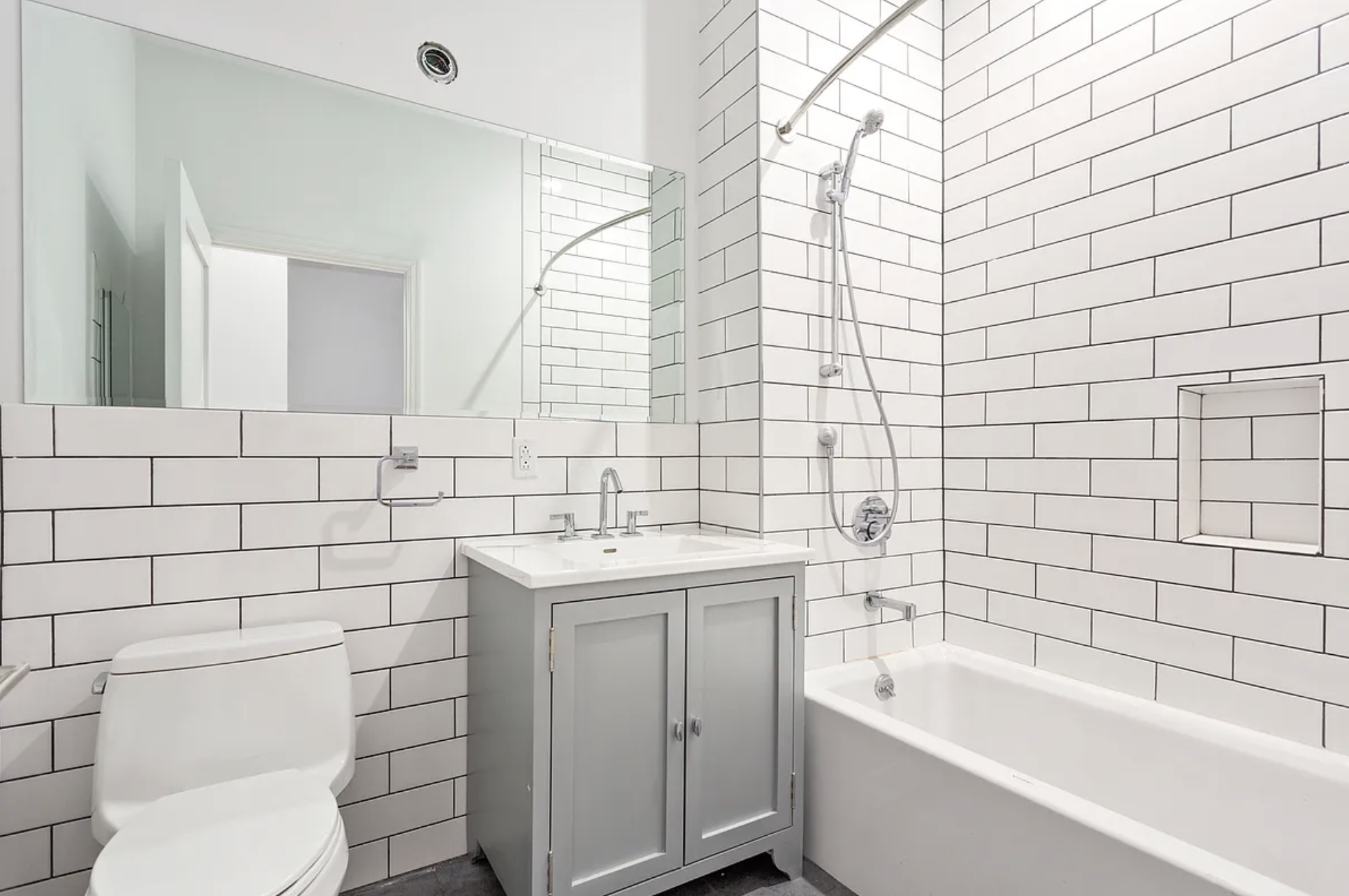 281 Grand Street, Unit 2R Manhattan, NY 10002 - Photo 4 of 5 a bathroom with a sink a toilet and mirror