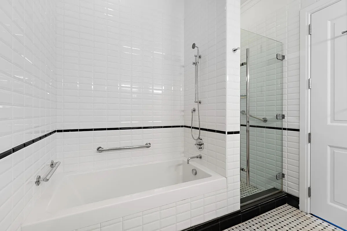 655 6th Avenue, Unit 5E Manhattan, NY 10010 - Photo 10 of 15 a bathroom with a bathtub and a shower
