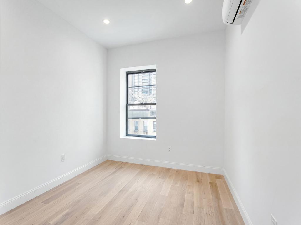 231 East 60th Street, Unit 5 Manhattan, NY 10022 - Photo 10 of 11 an empty room with a window