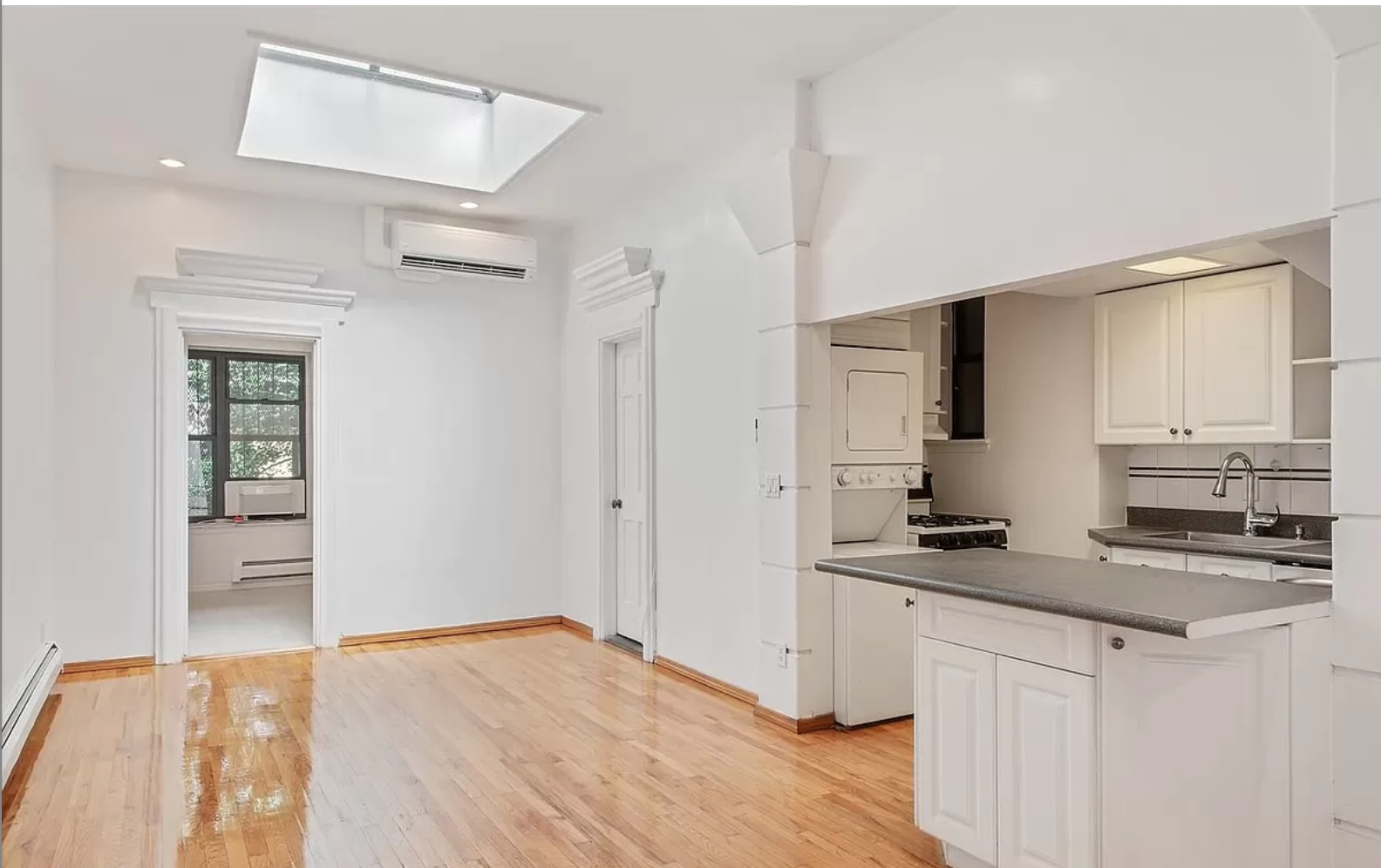 218 3rd Avenue, Unit 2 Manhattan, NY 10003 - Photo 2 of 9 a kitchen with a refrigerator stove and white cabinets