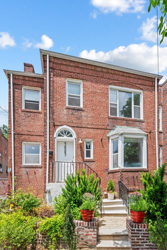 a front view of a house with a garden