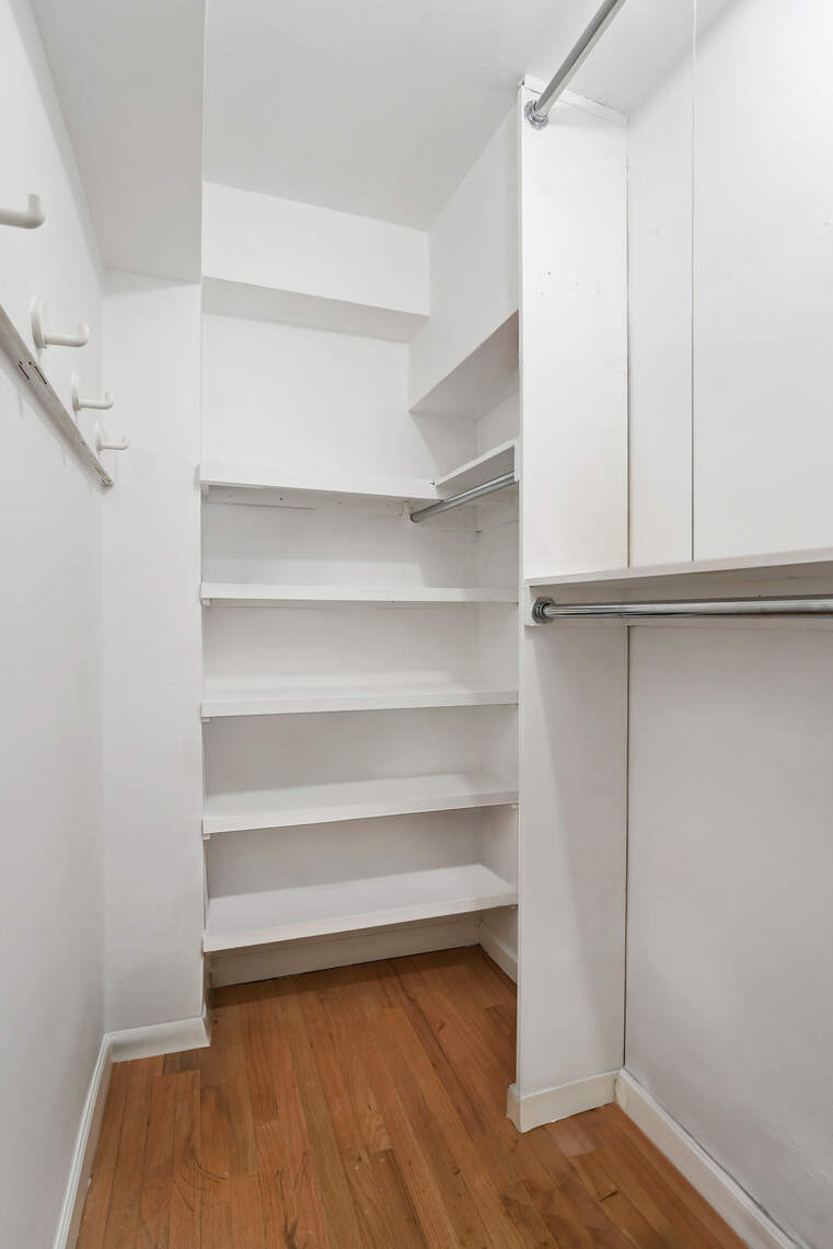 321 East 45th Street, Unit 1F Manhattan, NY 10017 - Photo 8 of 14 a view of walk in closet with empty racks