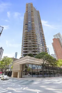 a view of a tall building next to a road