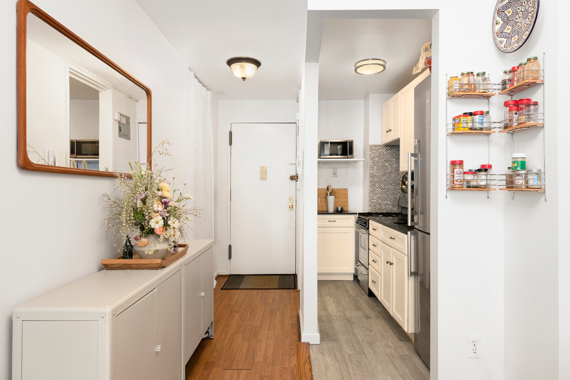 195 Willoughby Avenue, Unit 205 Brooklyn, NY 11205 - Photo 5 of 7 a kitchen with stainless steel appliances a chimney a sink and wooden floor