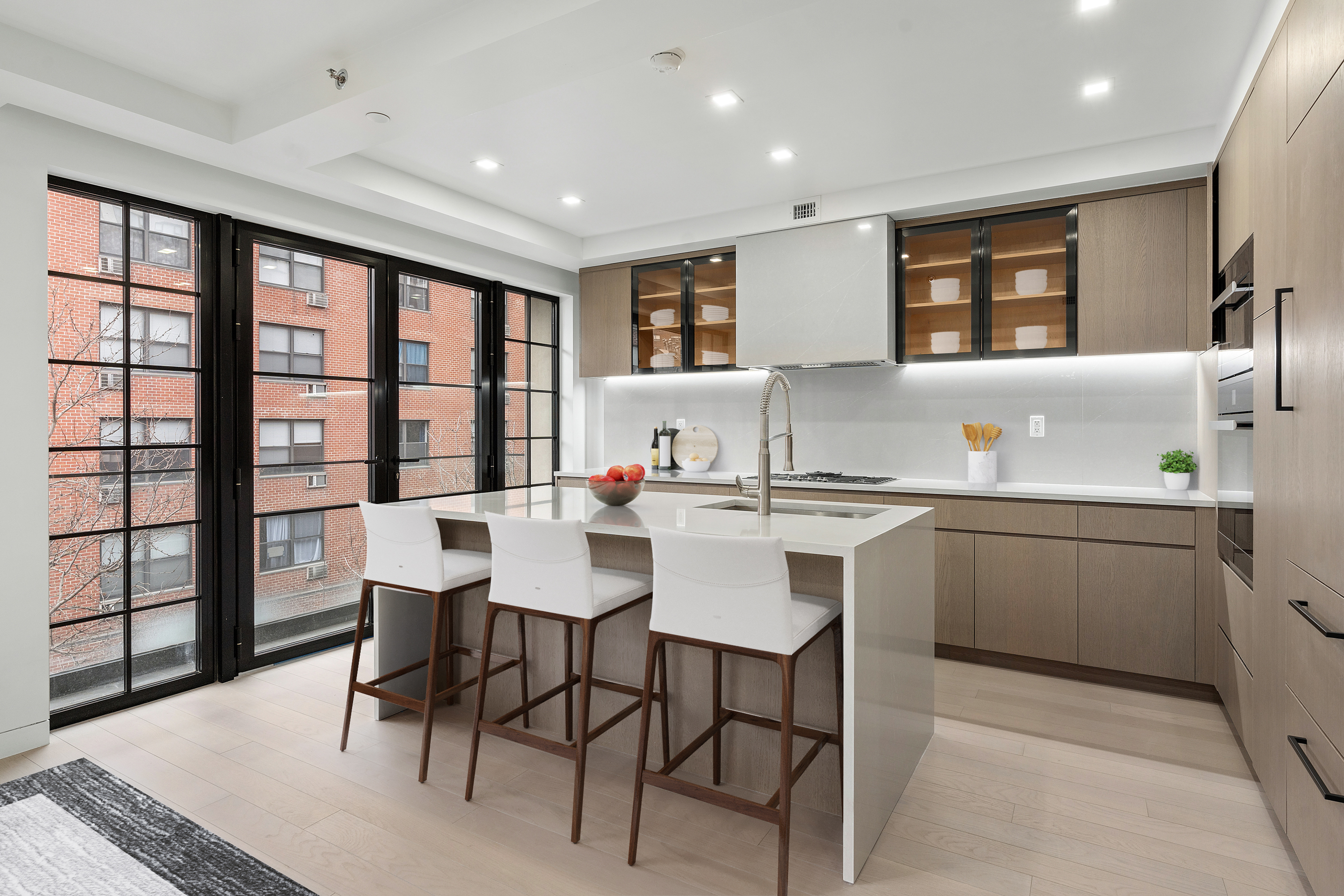 327 East 22nd Street, Unit 3A Manhattan, NY 10010 - Photo 5 of 14 a kitchen with a table chairs sink and cabinets