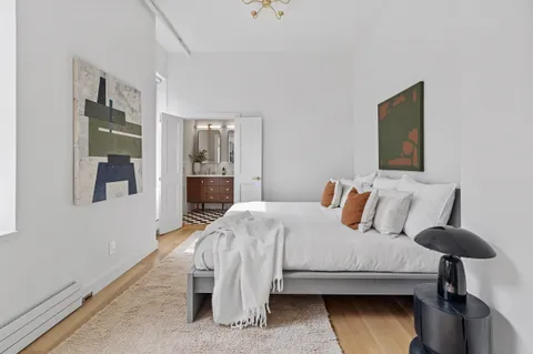 a bedroom with a bed and a table