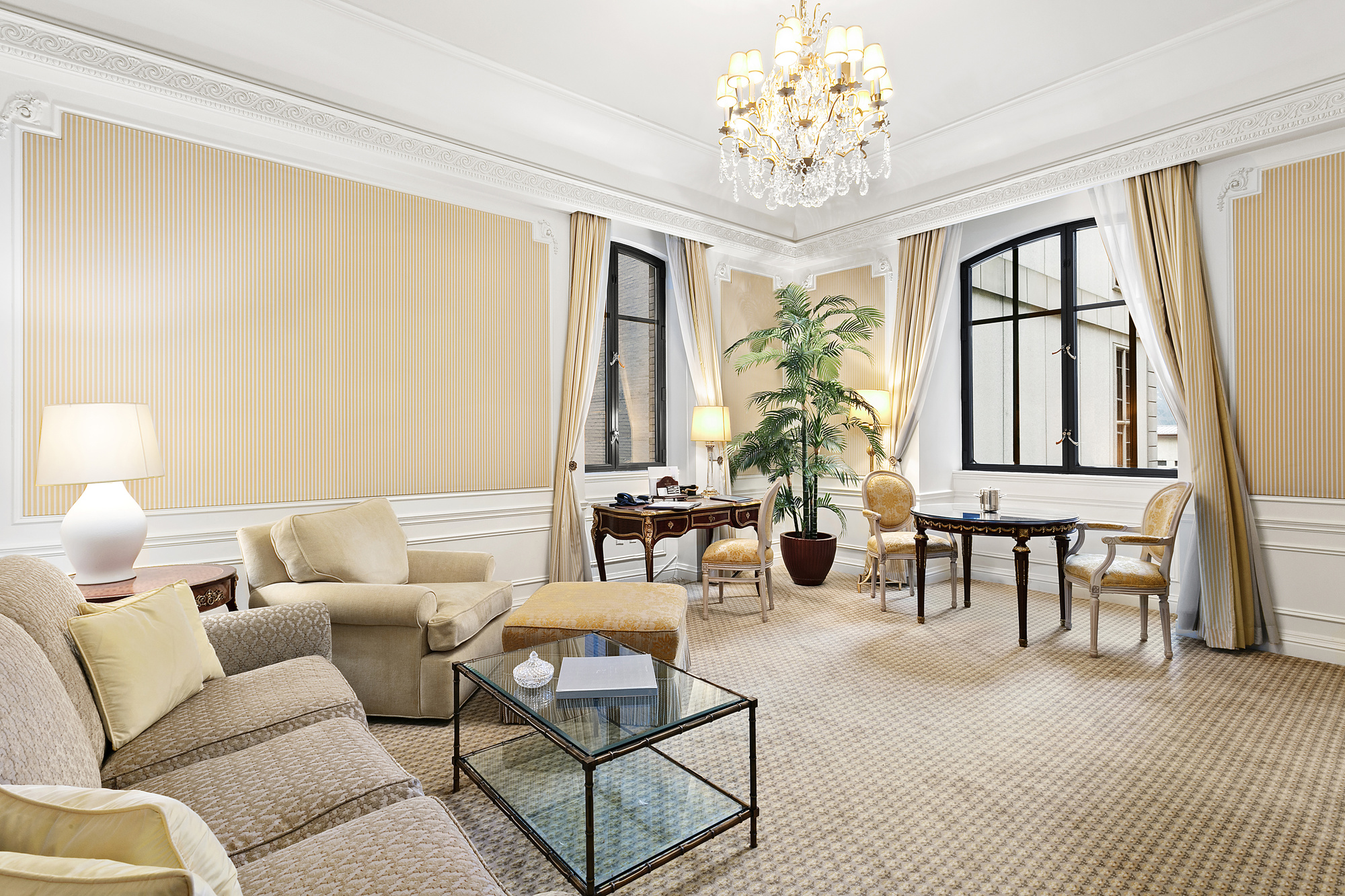a living room with furniture a fireplace and large windows