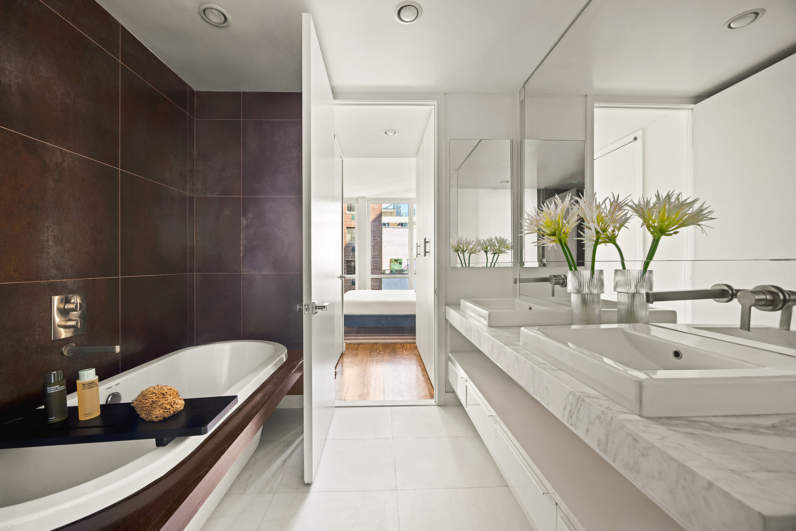 133 West 22nd Street, Unit 8G Manhattan, NY 10011 - Photo 8 of 16 a bathroom with a tub sink and mirror