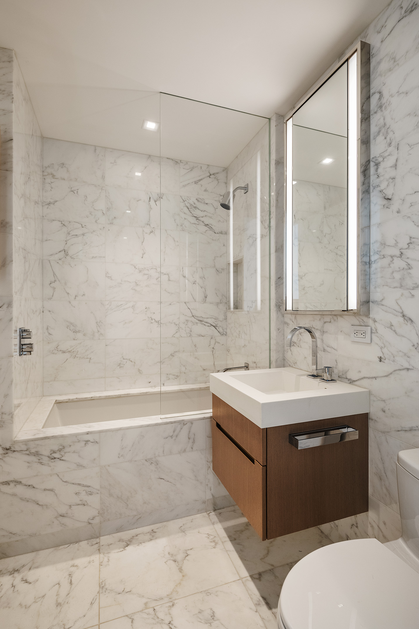1 West End Avenue, Unit 22E Manhattan, NY 10023 - Photo 10 of 32 a bathroom with a sink a toilet and bathtub