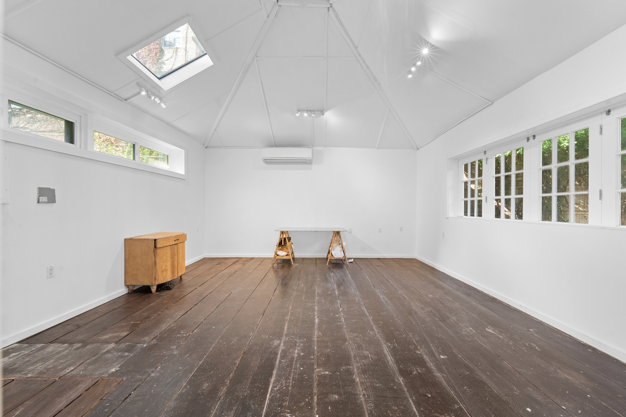 428 East 18th Street Brooklyn, NY 11226 - Photo 17 of 19 an empty room with wooden floor and windows