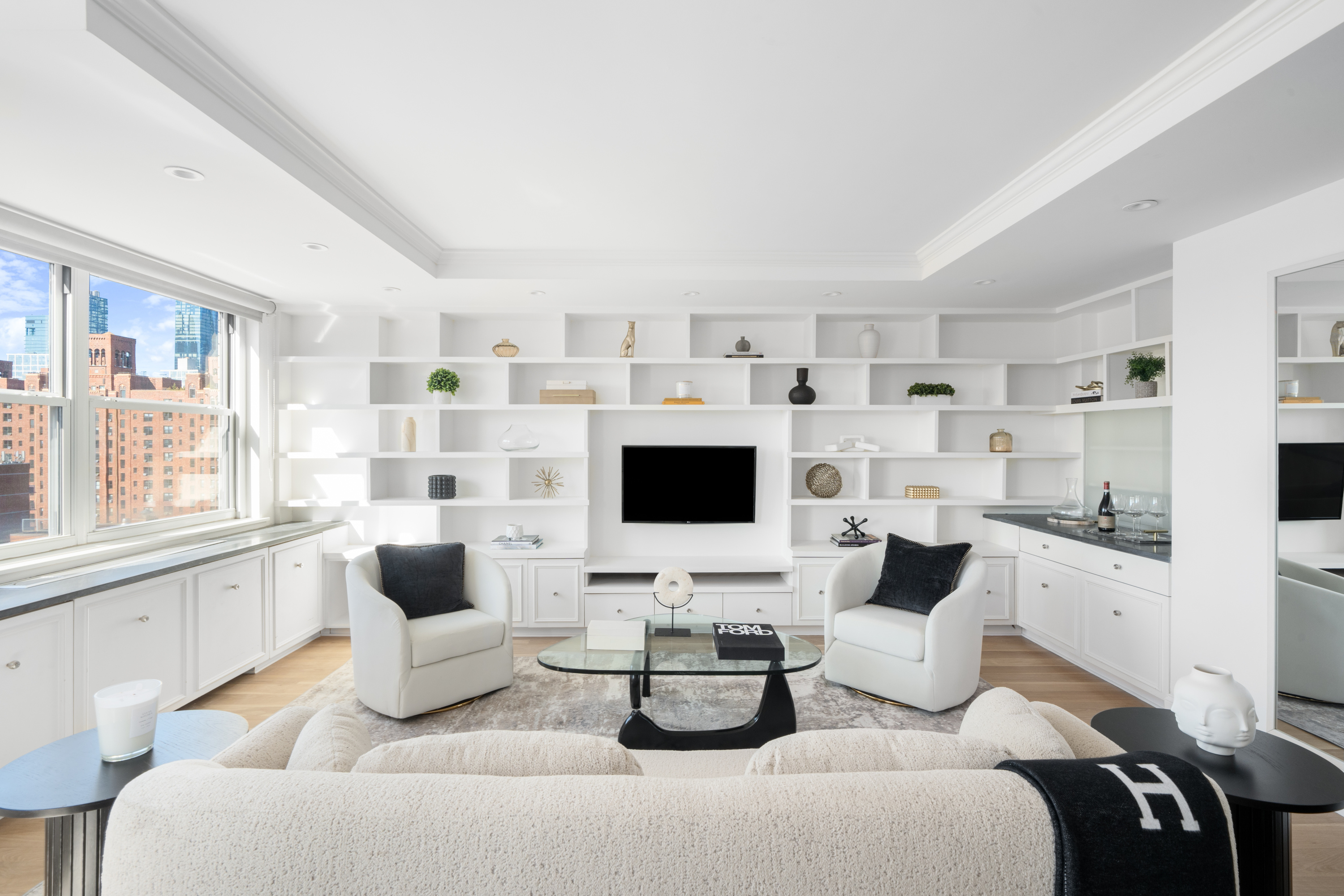 360 West 22nd Street, Unit 15C-14C Manhattan, NY 10011 - Photo 3 of 16 a living room with furniture and a flat screen tv