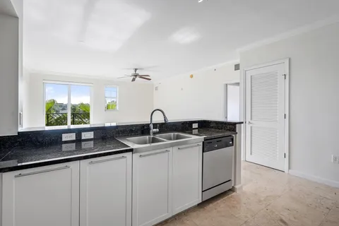 a kitchen with stainless steel appliances granite countertop a sink and a granite counter tops