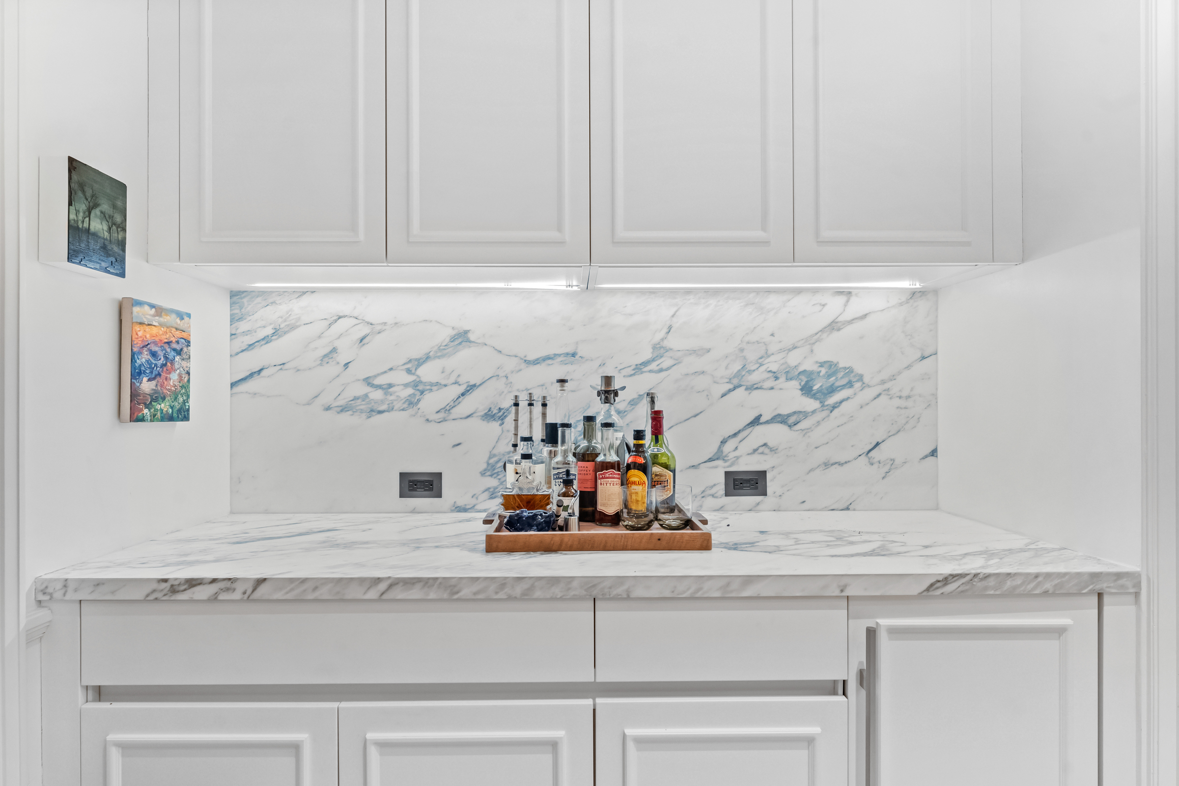 108 Leonard Street, Unit 4K Manhattan, NY 10013 - Photo 5 of 11 a kitchen with white cabinets and a counter top