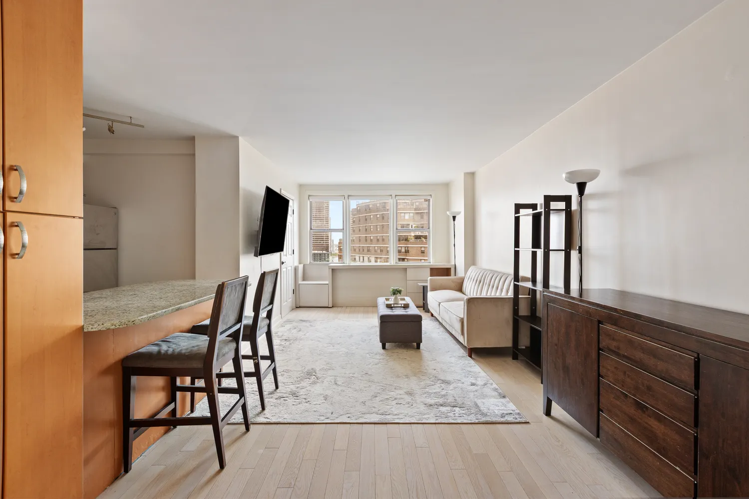 a dining room with furniture and wooden floor