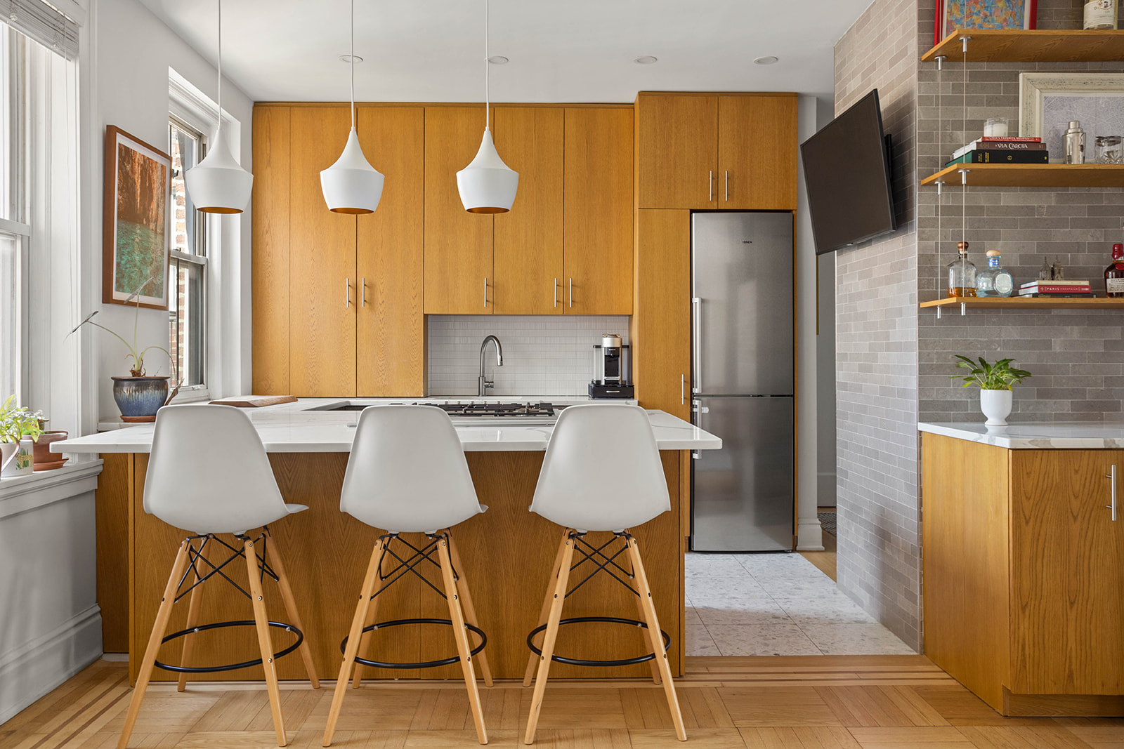 34-28 80th Street, Unit 41 Queens, NY 11372 - Photo 4 of 15 a kitchen with stainless steel appliances granite countertop a table chairs and a refrigerator