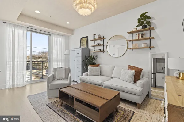 a living room with furniture a rug and a window
