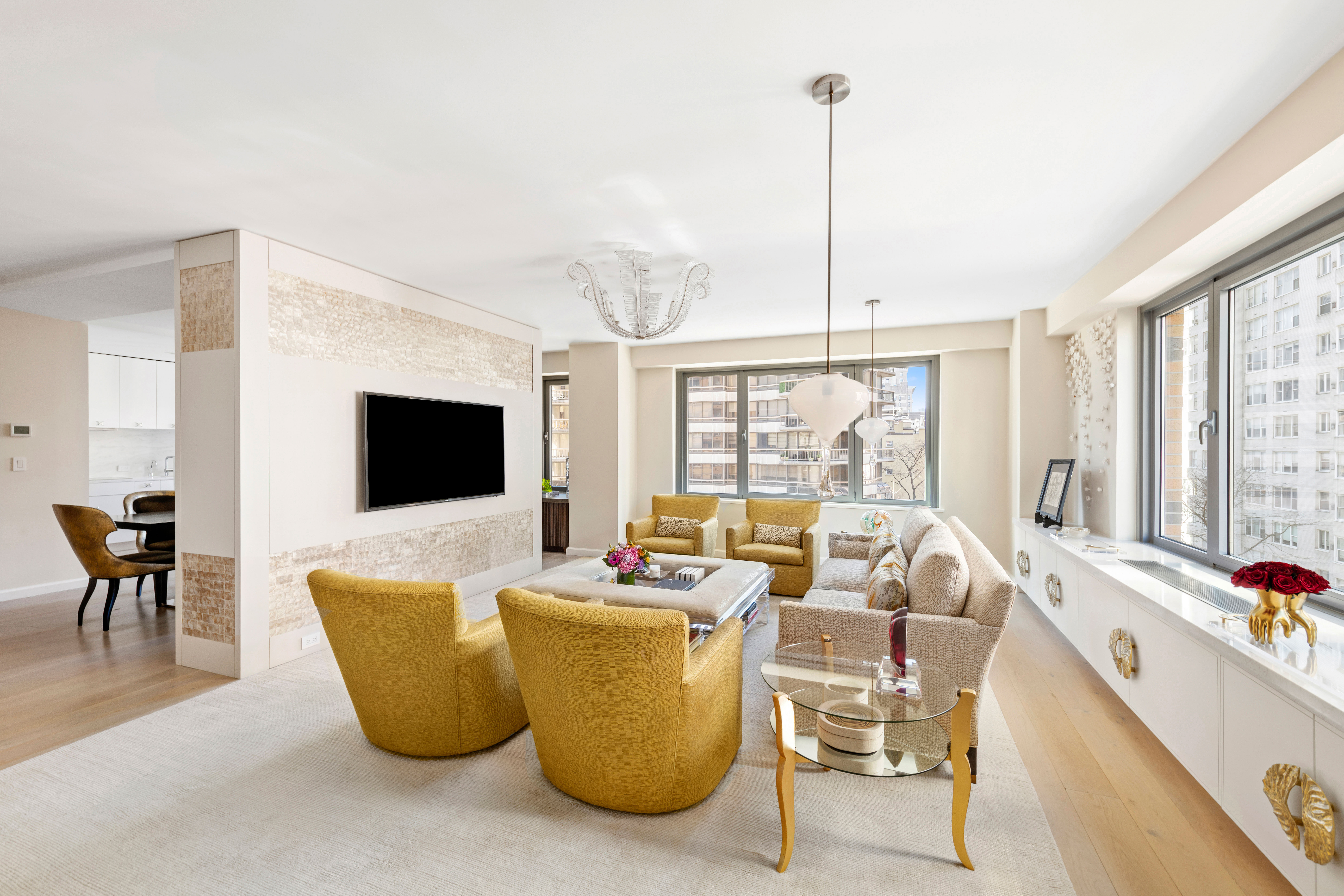 200 East 62nd Street, Unit 5A Manhattan, NY 10065 - Photo 4 of 25 a living room with furniture a flat screen tv and a large window
