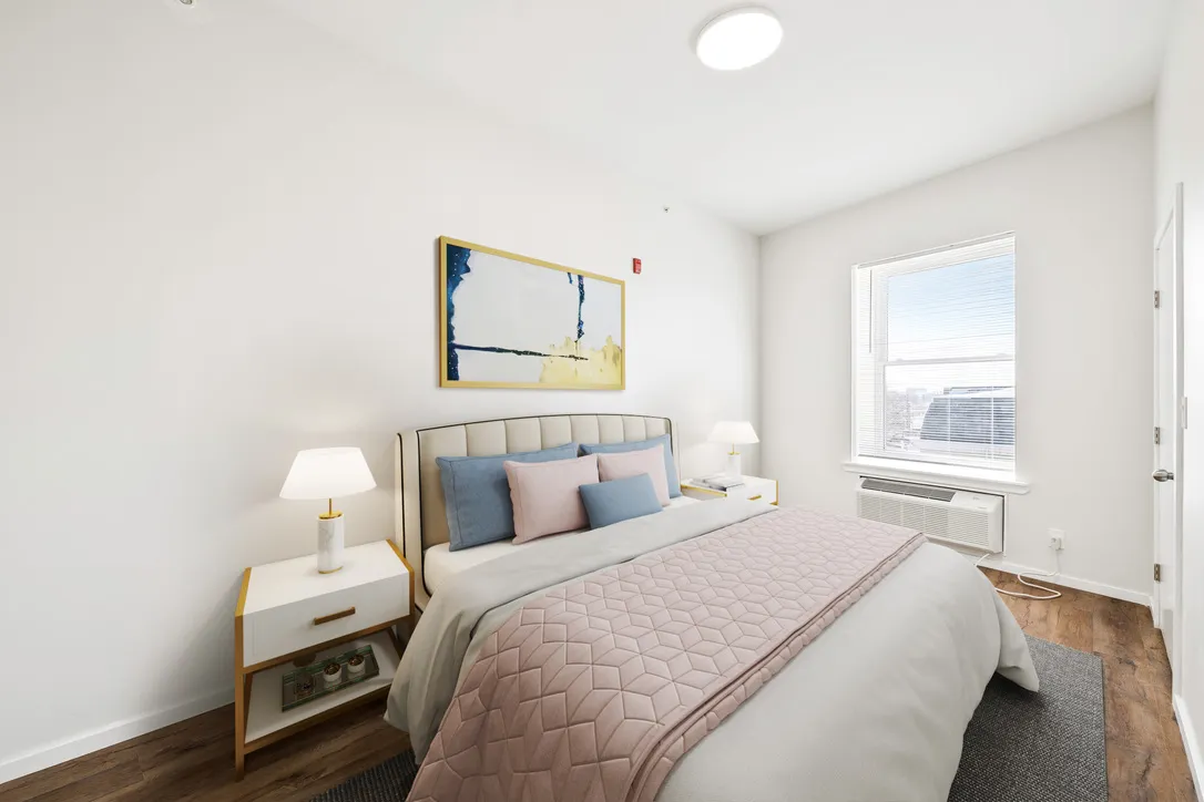 a bedroom with a bed a mirror and a flat screen tv