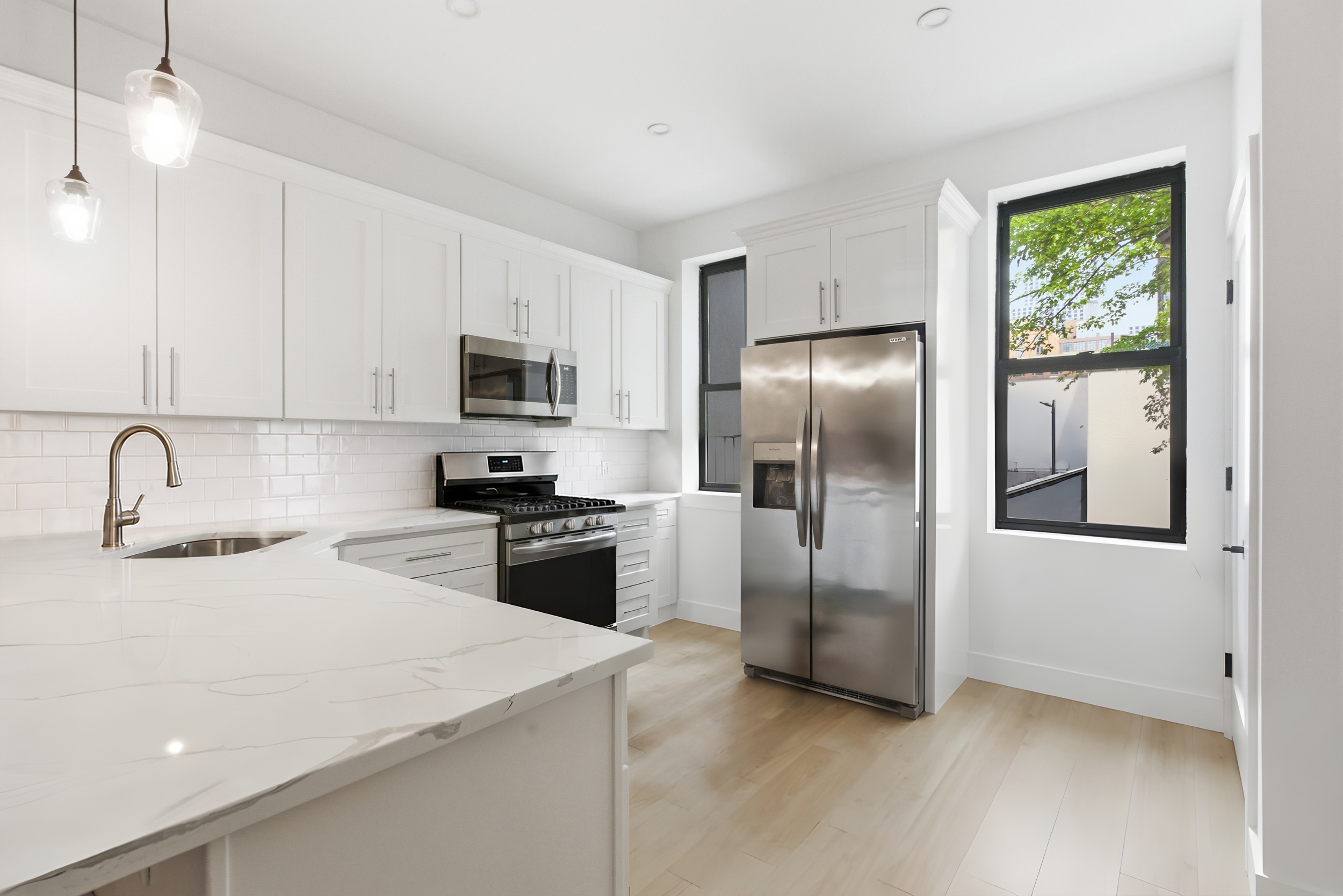 29 Greenpoint Avenue Brooklyn, NY 11222 - Photo 10 of 18 a kitchen with stainless steel appliances granite countertop a refrigerator a stove a sink and a microwave