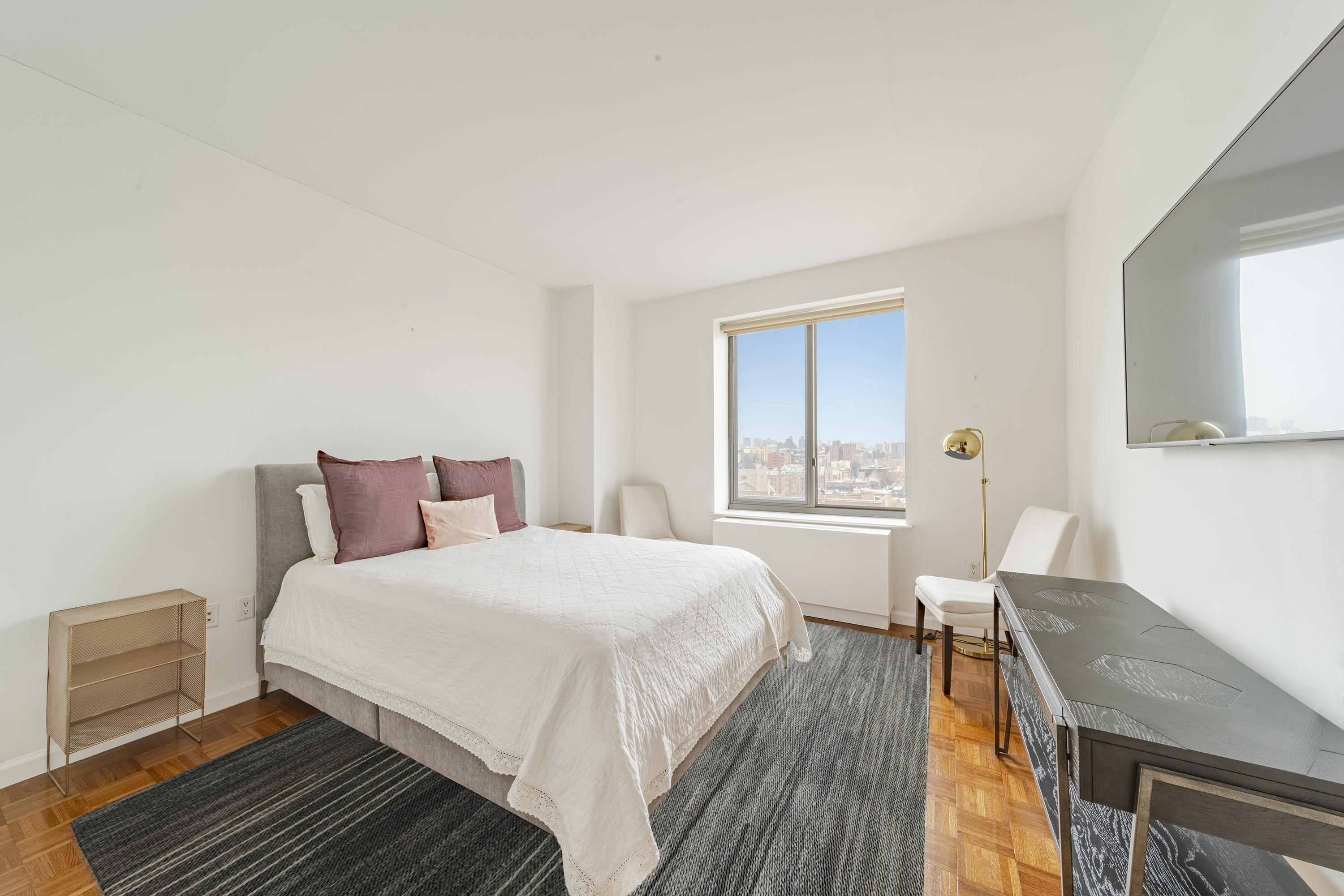 300 West 135th Street, Unit 12C Manhattan, NY 10030 - Photo 4 of 9 a bedroom with a bed and wooden floor