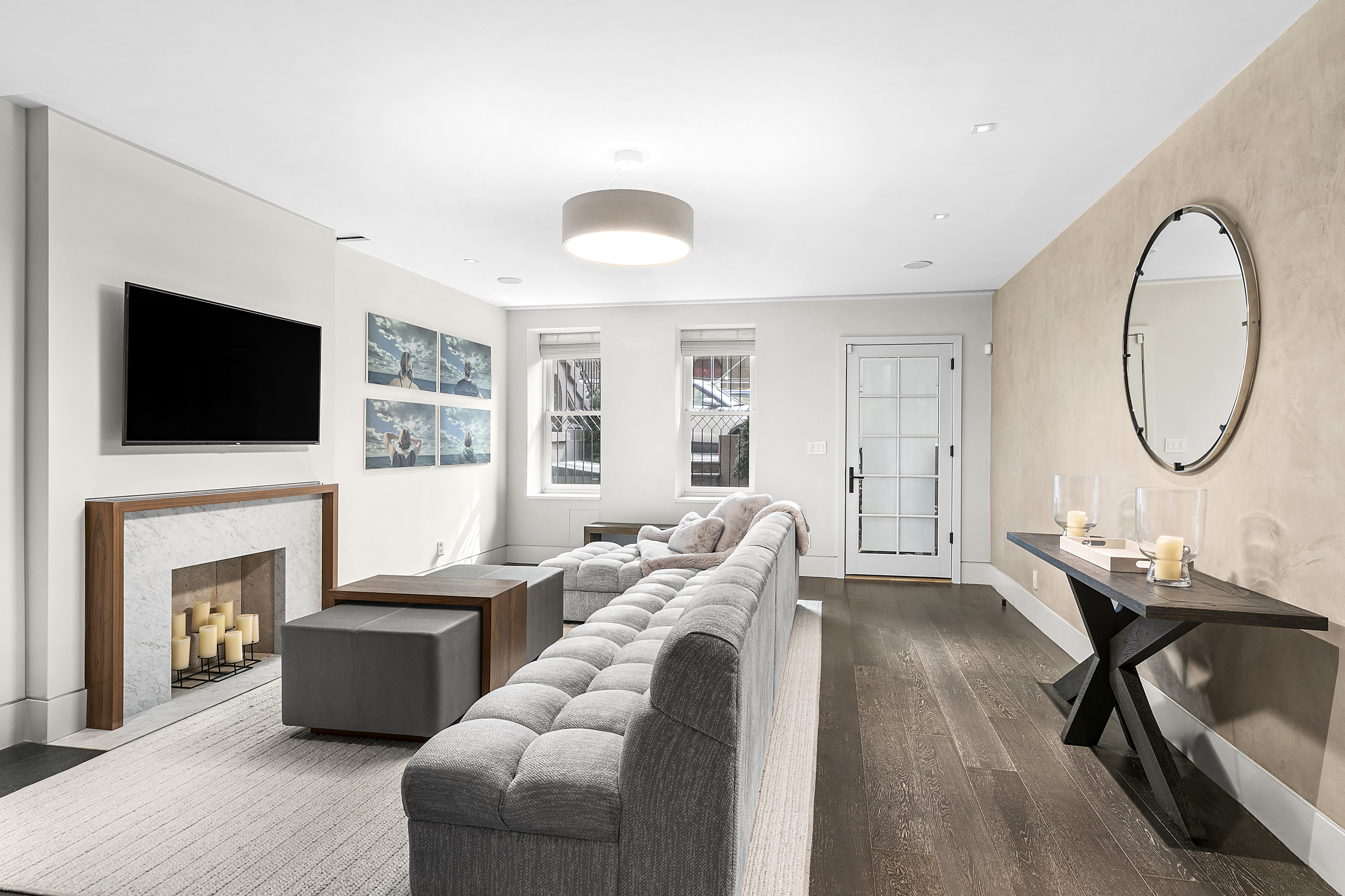 36 East 64th Street Manhattan, NY 10065 - Photo 7 of 27 a living room with furniture a fireplace and a flat screen tv