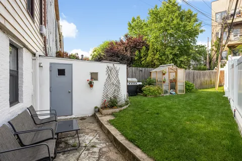 a backyard of a house with table and chairs