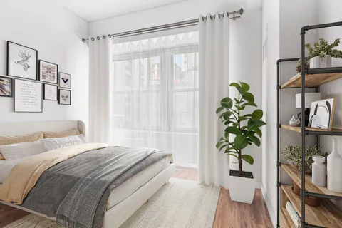 a bedroom with a bed and a potted plant