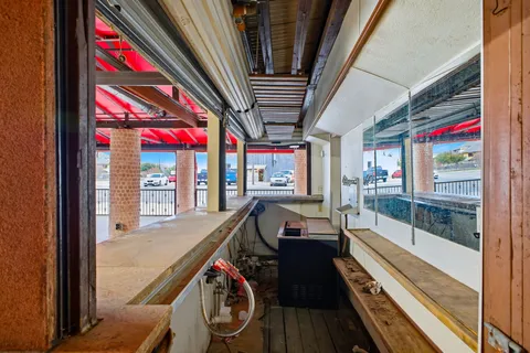 a view of a house with a wooden fence