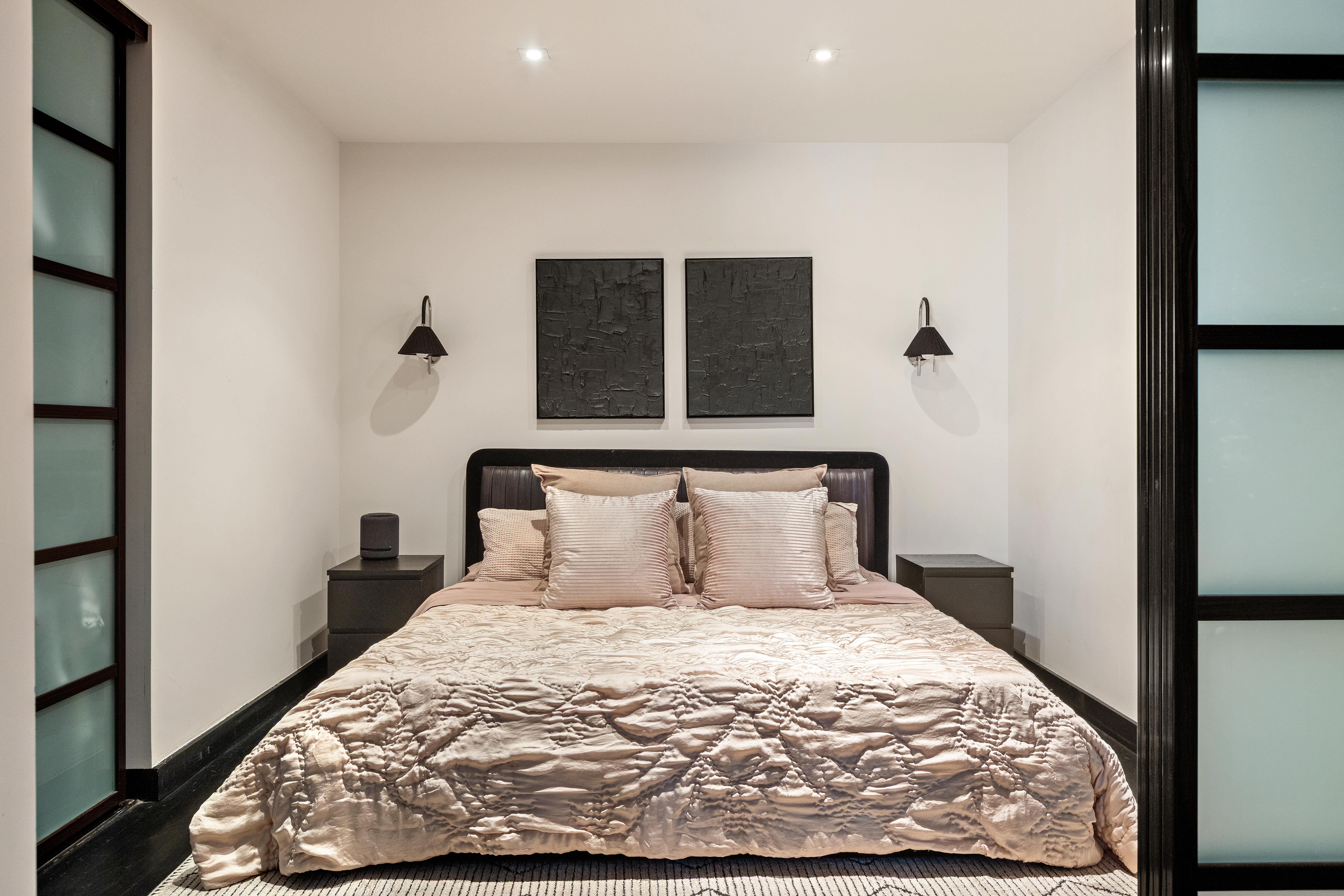 20 Pine Street, Unit 1205 Manhattan, NY 10005 - Photo 2 of 17 a large bed sitting in a bedroom next to a window