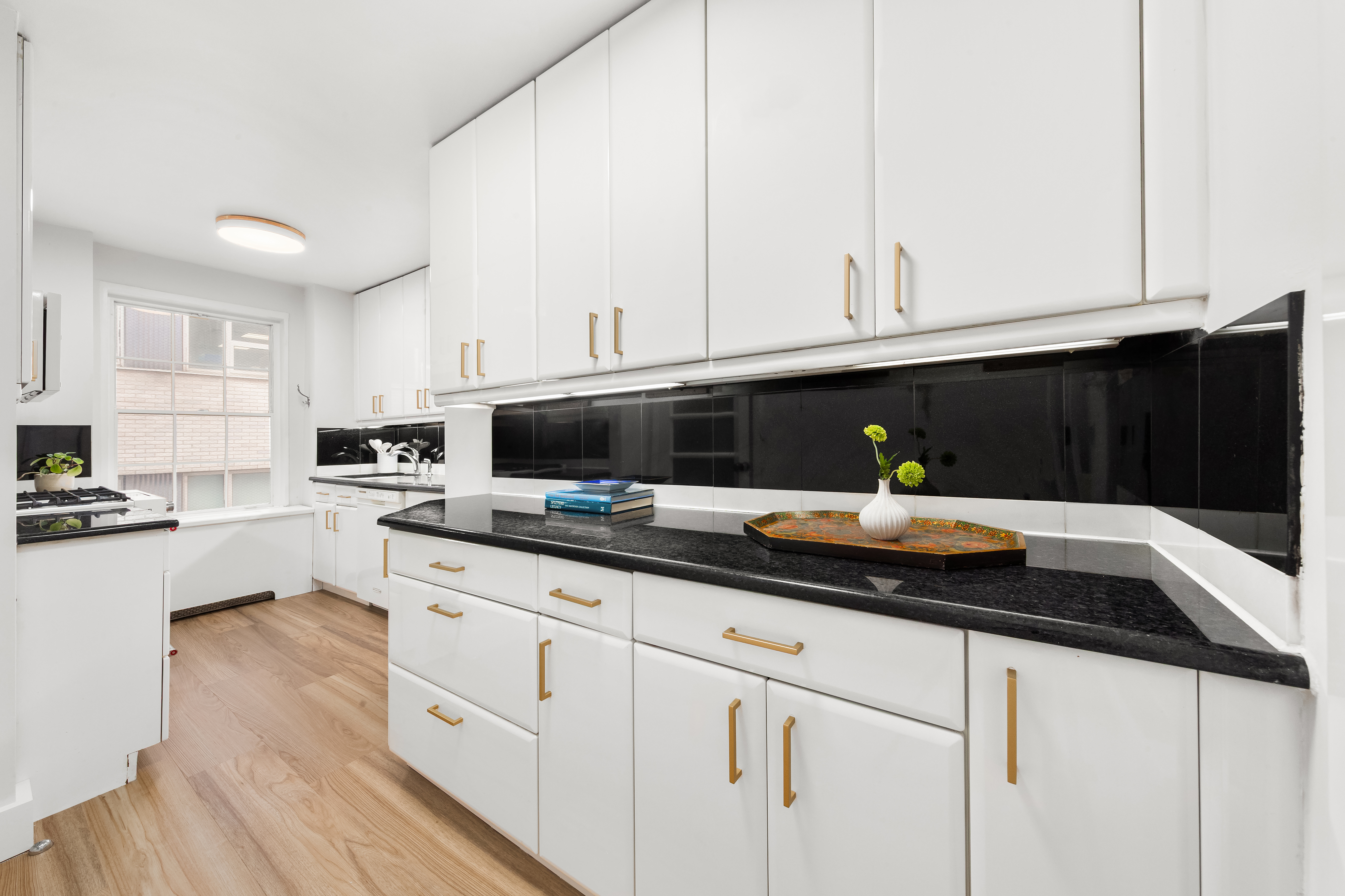 530 East 72nd Street, Unit 4F Manhattan, NY 10021 - Photo 6 of 23 a kitchen with a sink and cabinets