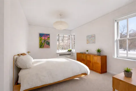 a bedroom with a bed and window