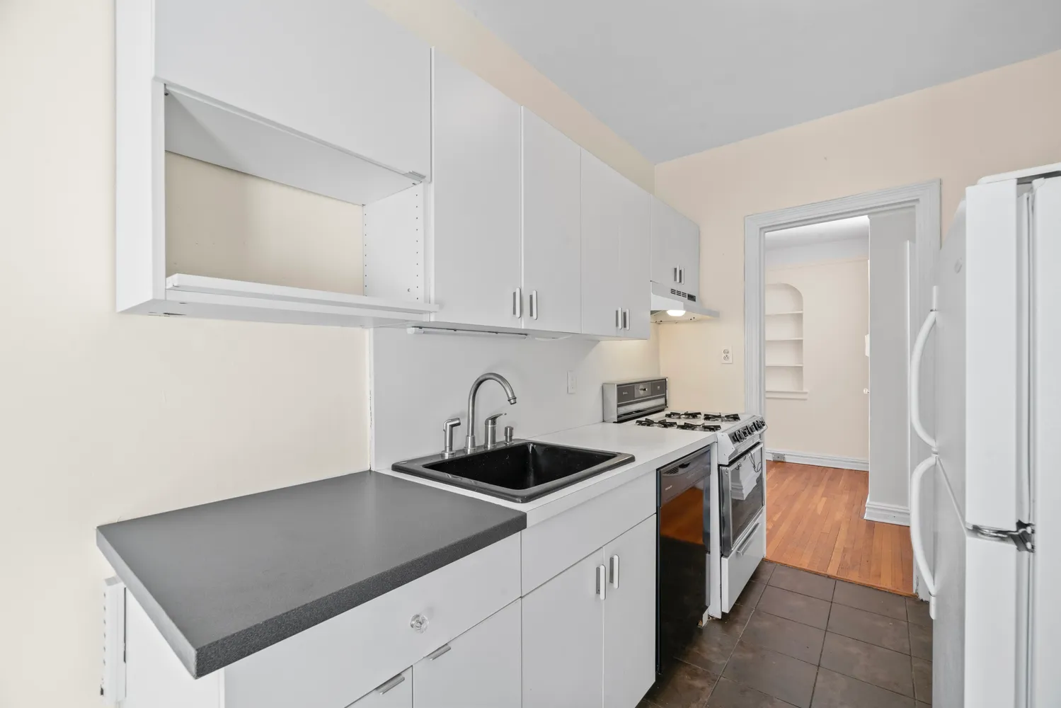 a kitchen with stainless steel appliances granite countertop a sink stove and refrigerator