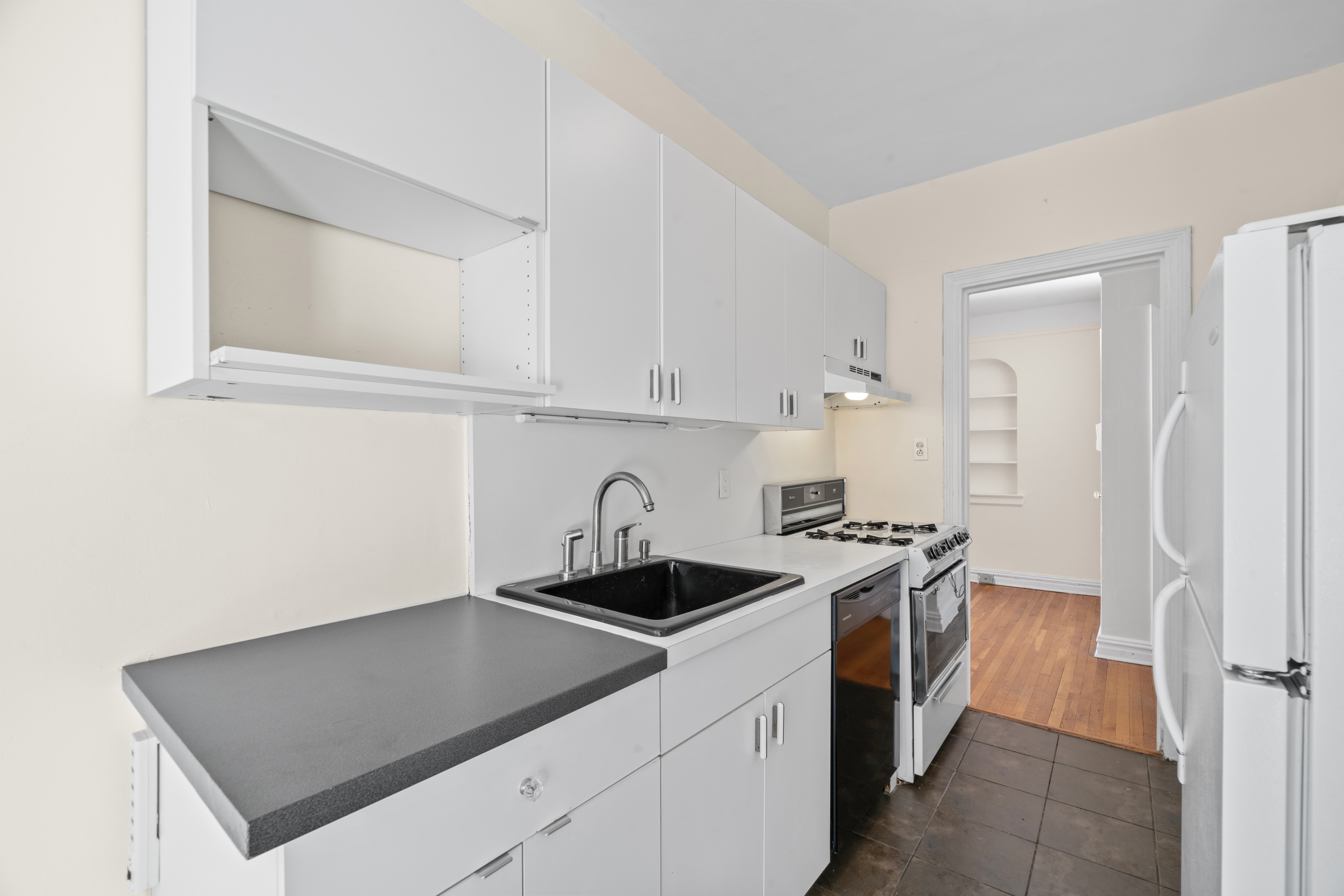 40 Tehama Street, Unit 6E Brooklyn, NY 11218 - Photo 8 of 16 a kitchen with stainless steel appliances granite countertop a sink stove and refrigerator