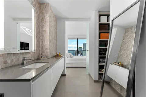 a large bathroom with a double vanity sink a mirror and shower