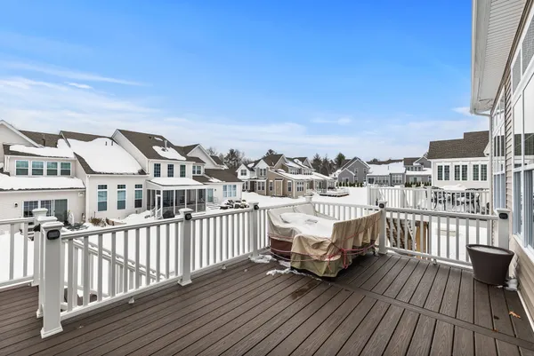 a view of a house with a barbeque and wooden deck