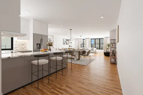 a open kitchen with white cabinets and stainless steel appliances