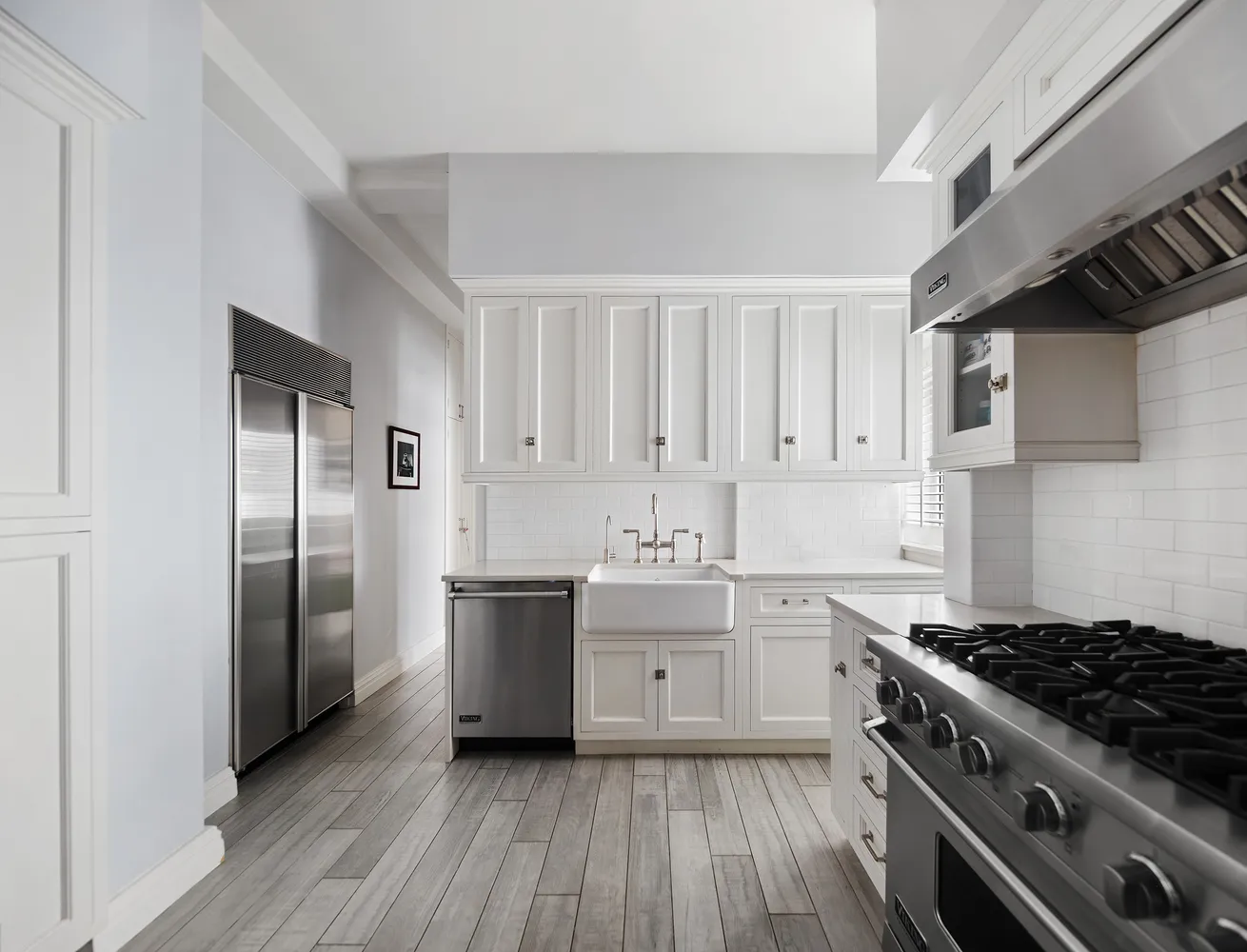 a bedroom with a bed and a window with balcony view