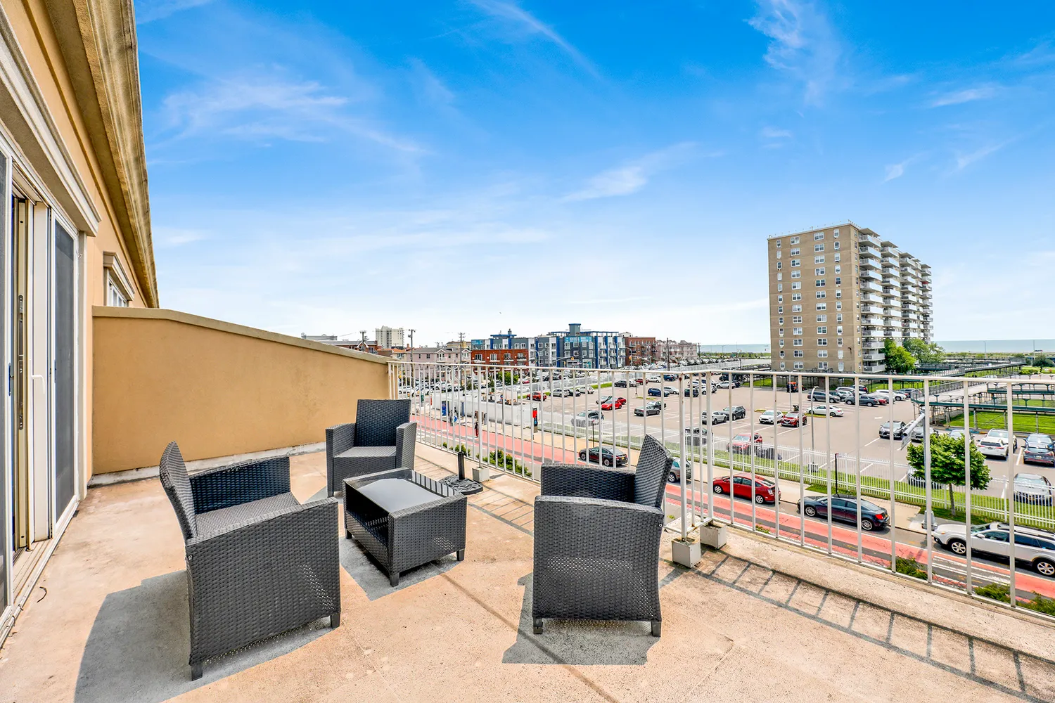 a view of roof with potted plants and city view