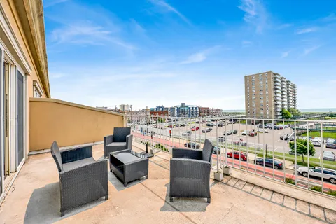 a view of roof with potted plants and city view