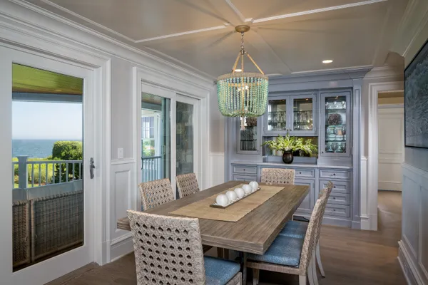 a view of a dining room with furniture wooden floor and chandelier