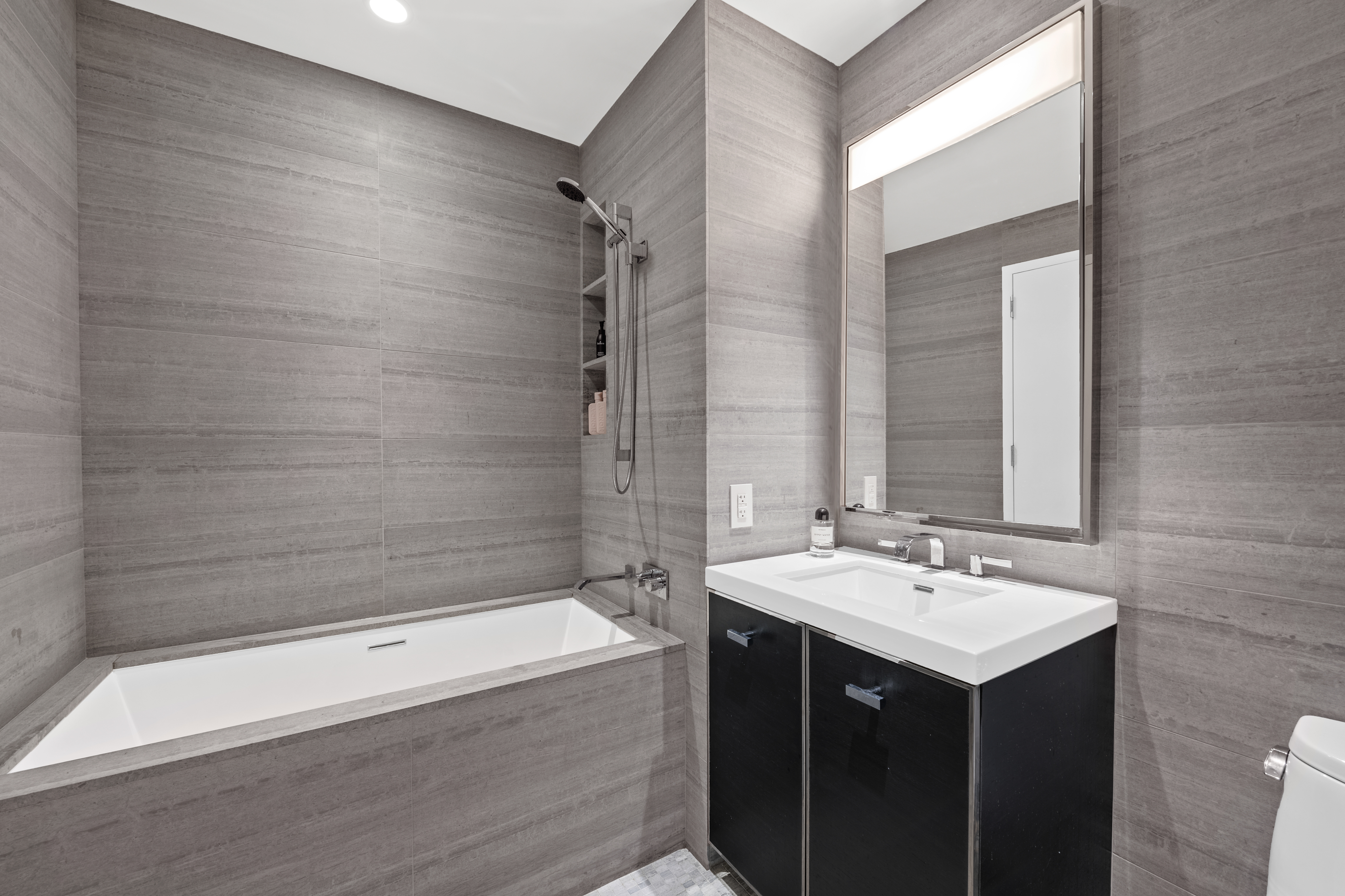 252 South Street, Unit 60G Manhattan, NY 10002 - Photo 7 of 30 a bathroom with a sink and a mirror